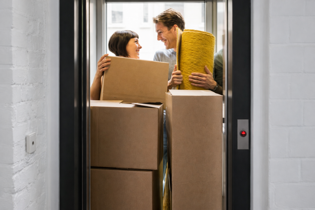 Professional movers loading boxes into a truck outside a Michigan apartment building.
